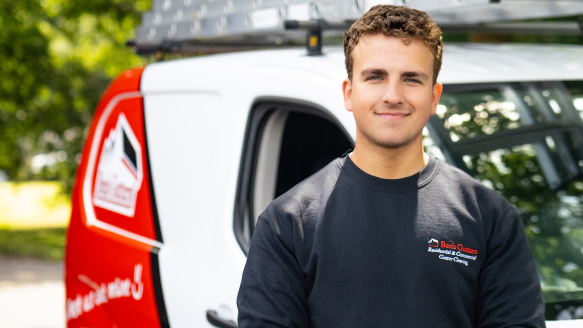 A Ben's Gutters subcontractor beside a branded van